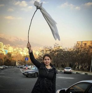 An Iranian woman protests the obligatory Islamic headscarf by taking it off and waving it on a sticks in defiance of strict Islamic law in Tehran on Jan. 30, 2018. (Salampix/Abaca/Sipa via AP Images)